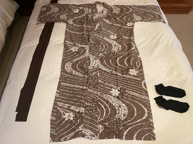 山のホテルのベッドの上に広げた浴衣と帯とソックス